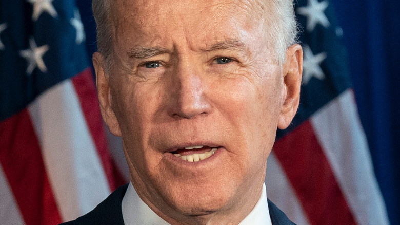 Joe Biden speaking onstage at a rally