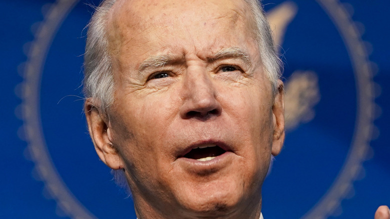 President Joe Biden speaks a podium