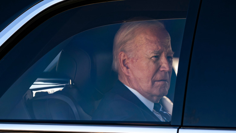 Joe Biden sitting in the back of a car