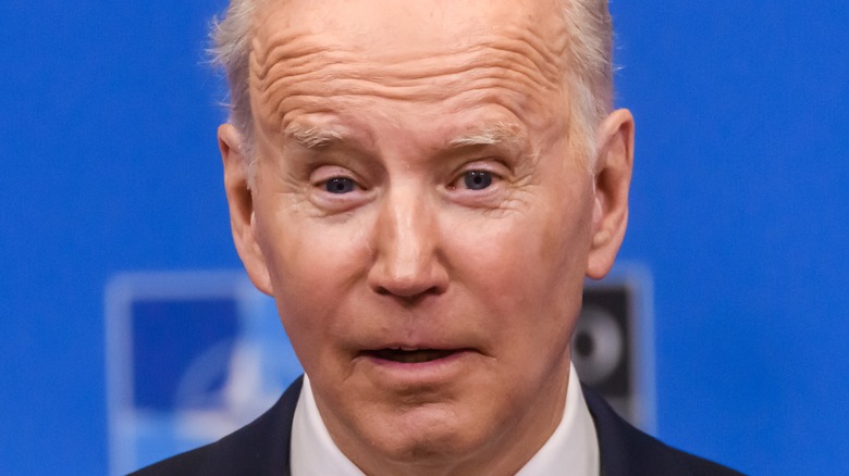 Joe Biden wearing sunglasses and looking sad