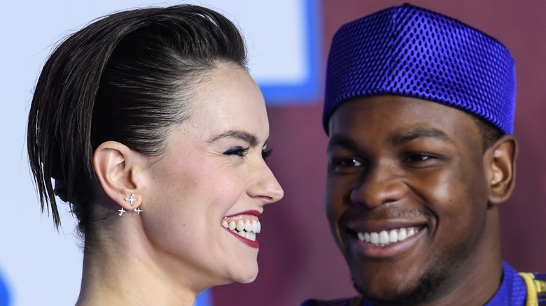 John Boyega and Daisy Ridley smiling 