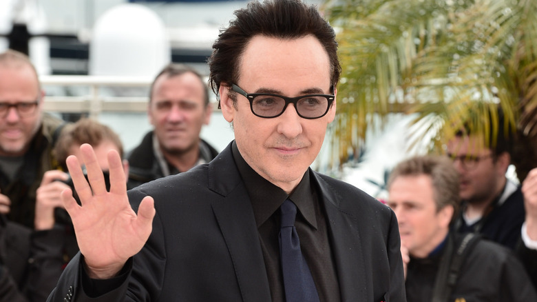 John Cusack waving fans on the red carpet