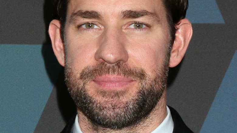 John Krasinski with slight smile on the red carpet