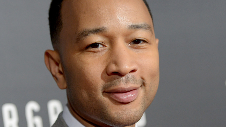 John Legend poses on the red carpet