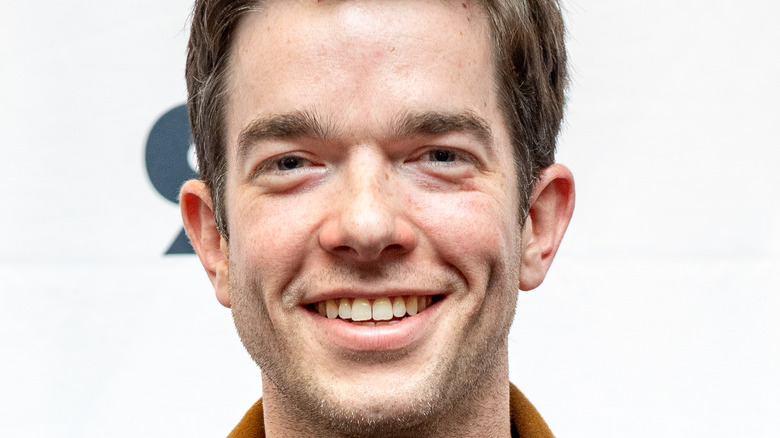 John Mulaney posing at event