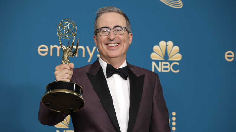 John Oliver holding an Emmy