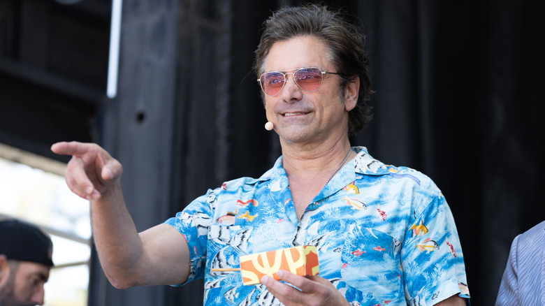 John Stamos pointing at an event
