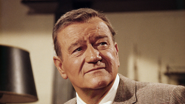 John Wayne looking pensive in a suit