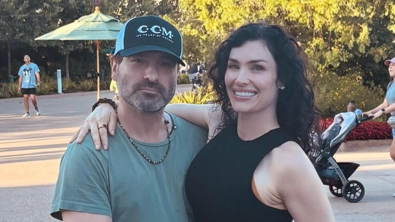 Johnny Galecki and Morgan Galecki embrace in front of EPCOT in Bay Lake, FL (2025)