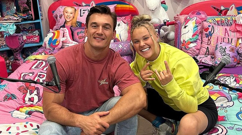 Tyler Cameron and JoJo Siwa on bed with Siwa bedding