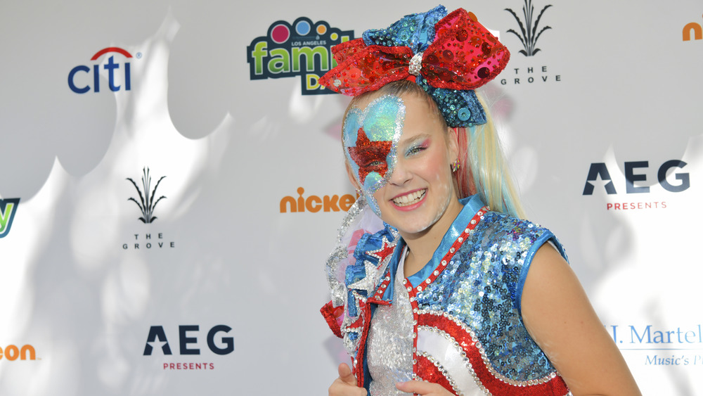 JoJo Siwa dressed in sparkly red, white, and blue