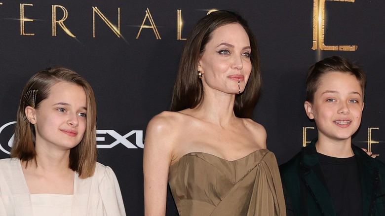 Angelina jolie posing on the red carpet with her children