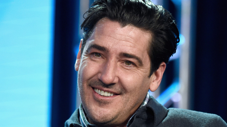 Portrait of Jonathan Knight grinning 