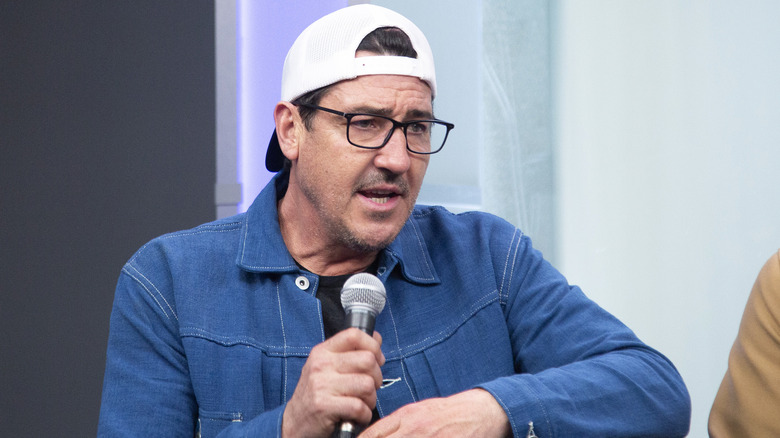 Jonathan Knight speaking into a microphone