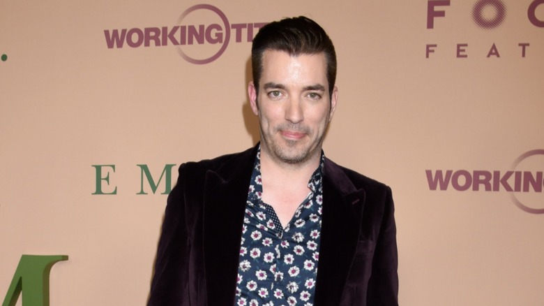 Jonathan Scott smiling in a floral shirt and black blazer