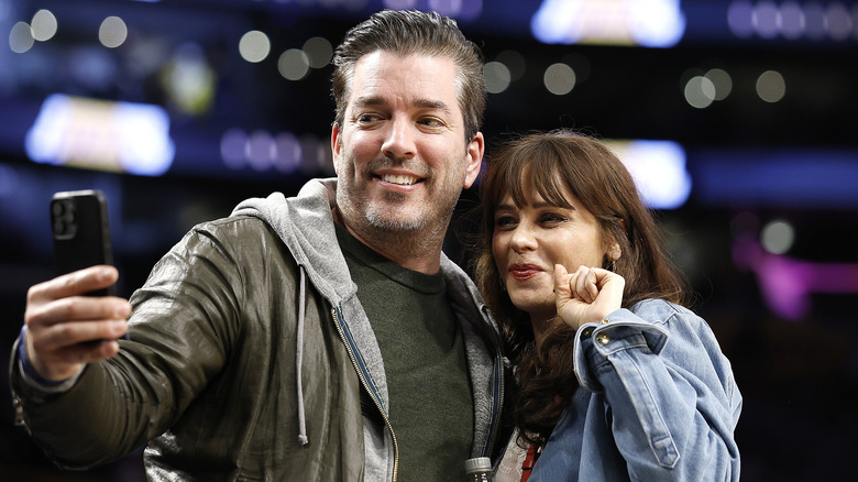 Zooey Deschanel and Jonathan Scott taking a selfie at a Lakers game