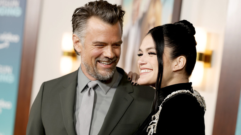 Josh Duhamel and Audra Mari sharing a laugh on the red carpet