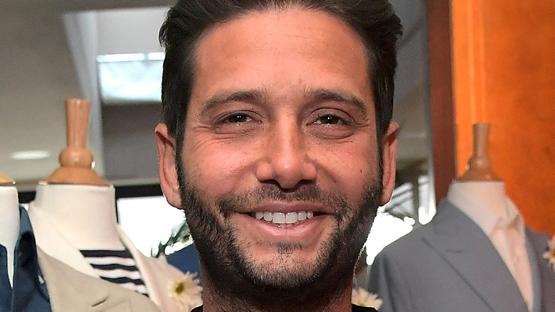 Josh Flagg smiles at an event