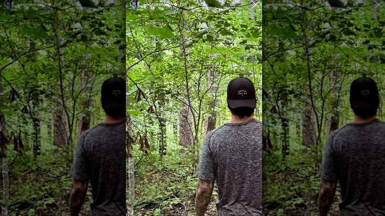 Josh Hall walking in the woods