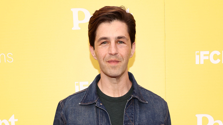 Josh Peck posing at premiere