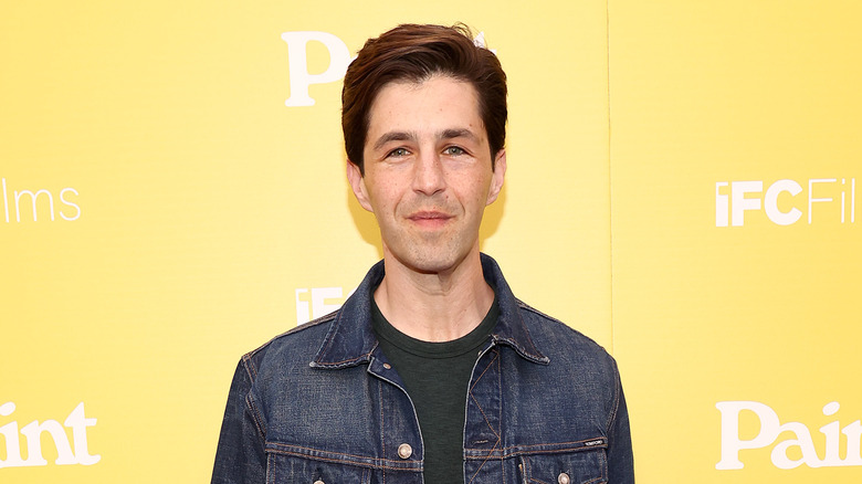 Josh Peck posing at premiere