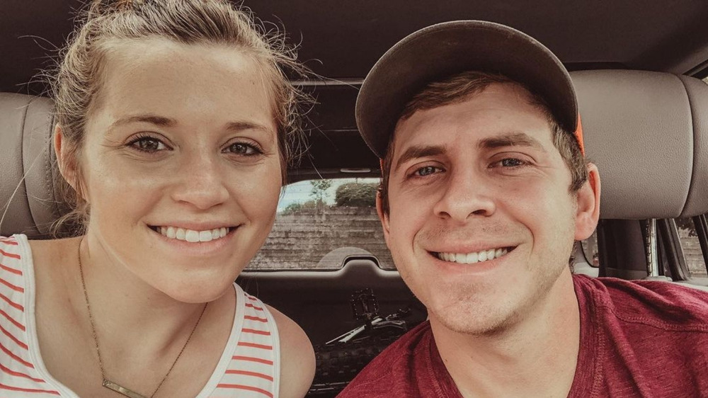 Joy Anna and Austin Duggar smiling inside car