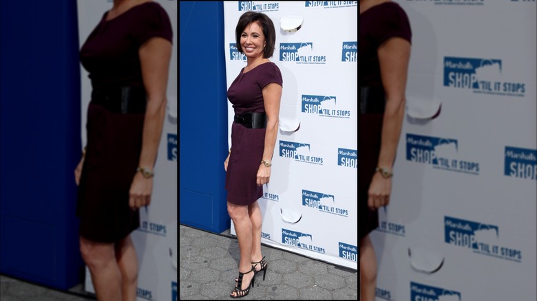 Judge Jeanine Pirro smiling in a violet dress.