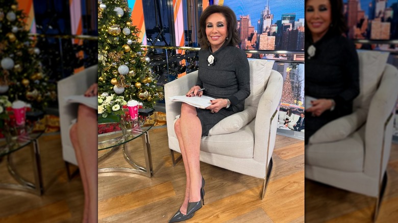 Judge Jeanine Pirro sitting down smiling in a black dress while at the studio.