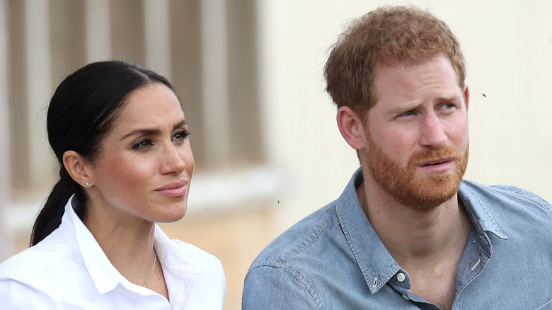 Meghan Markle and Prince Harry listening