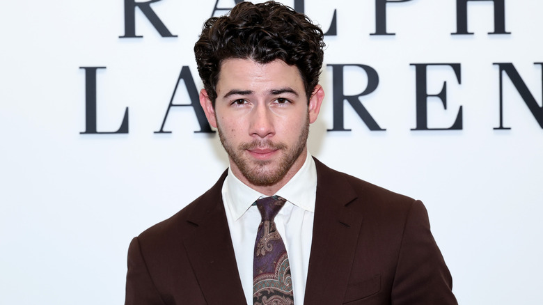 Nick Jonas in a brown suit
