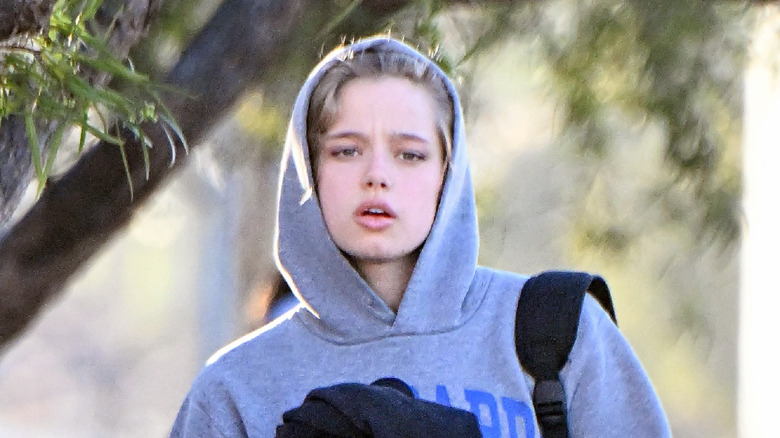 Shiloh Jolie-Pitt walking in gray hoodie