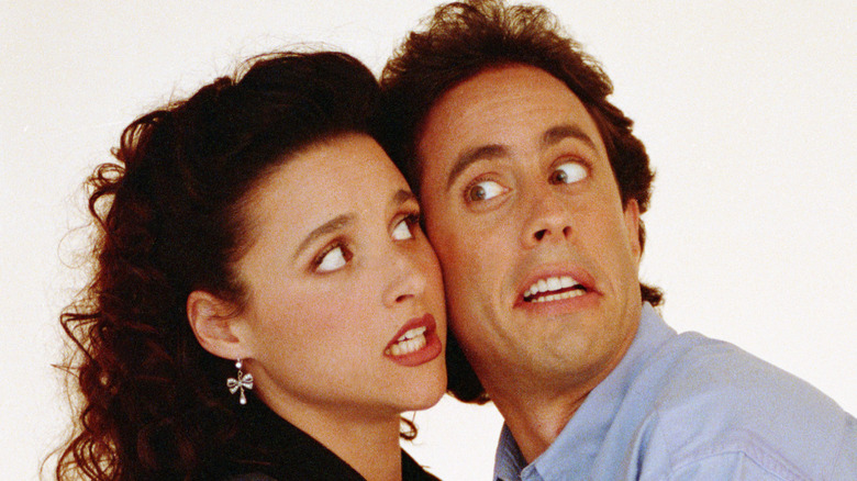 Julia Louis-Dreyfus and Jerry Seinfeld touching their faces together