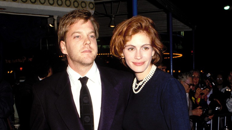 Kiefer Sutherland and Julia Roberts posing together and wearing black