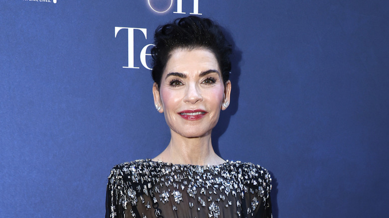 Julianna Margulies smiling in a black gown with silver embellishments