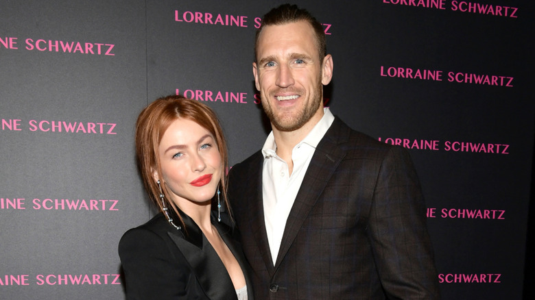 Julianne Hough with red hair and a red lip posing next to Brooks Laich