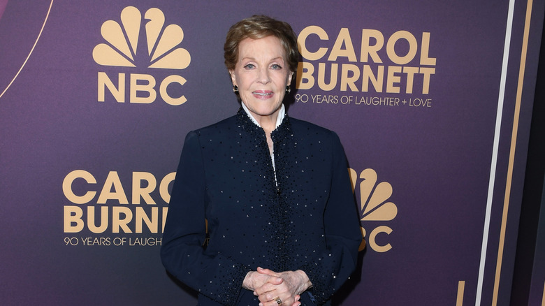 Julie Andrews clasping her hands together
