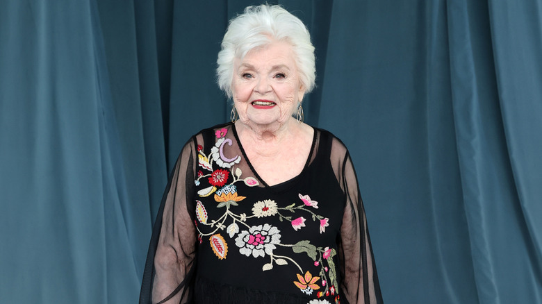 June Squibb smiling while posing on the red carpet