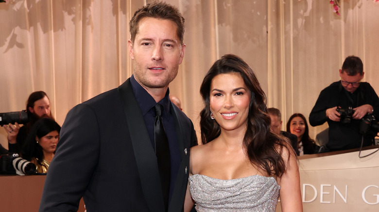 Justin Hartley and Sofia Pernas posing on the Golden Globes red carpet.