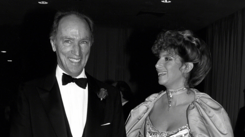 Canadian Prime Minister Pierre Trudeau gives a big smile as he escorts singer Barbara Streisand