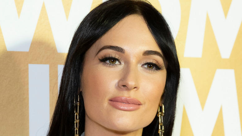 Kacey Musgraves posing on a red carpet