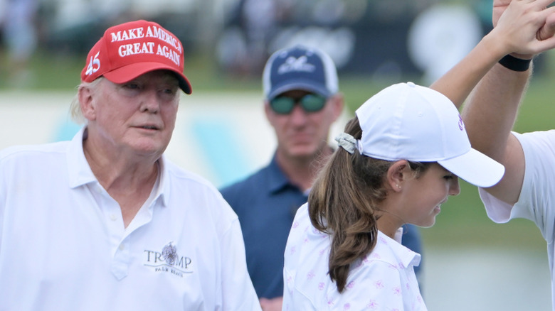 Donald Trump looking at Kai Trump