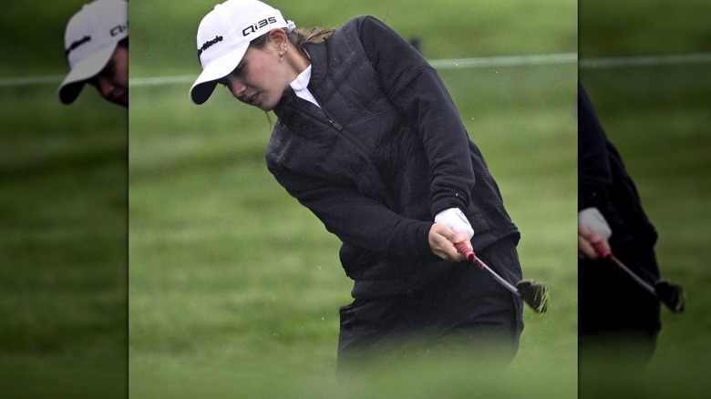 Kai Trump hitting a golf ball