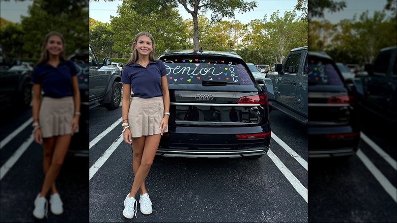 Kai Trump posing with car