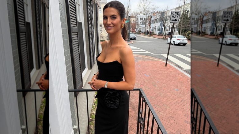 Kaitlan Collins on an outside balcony, wearing a low-cut black, strapless dress