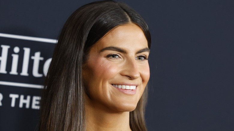 Photo of Kaitlan Collins smiling and staring off camera