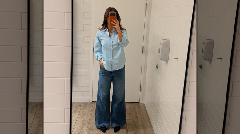 Kaitlan Collins taking a mirror selfie in jeans