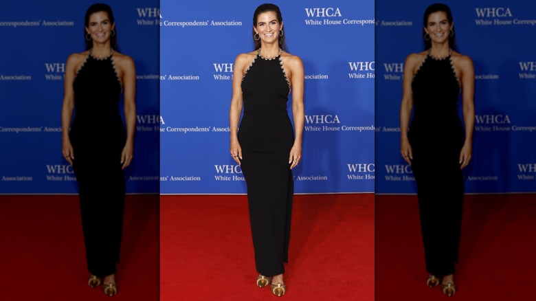 Kaitlan Collins smiling in a black dress at white house correspondents' dinner.