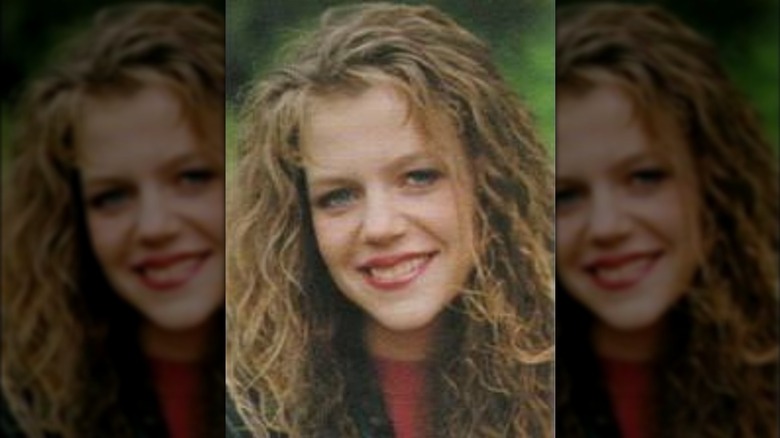 Kaitlin Olson smiles and wears her hair long and curly in her yearbook photo.