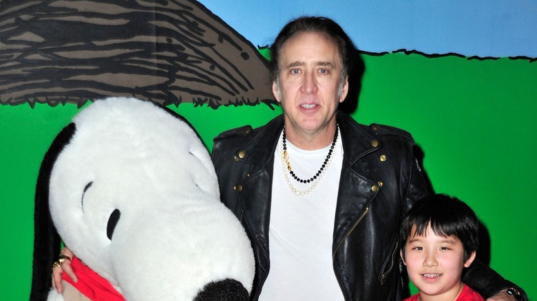 Nicolas Cage with Snoopy on his left and his son, Kal-El Coppola Cage, on his right