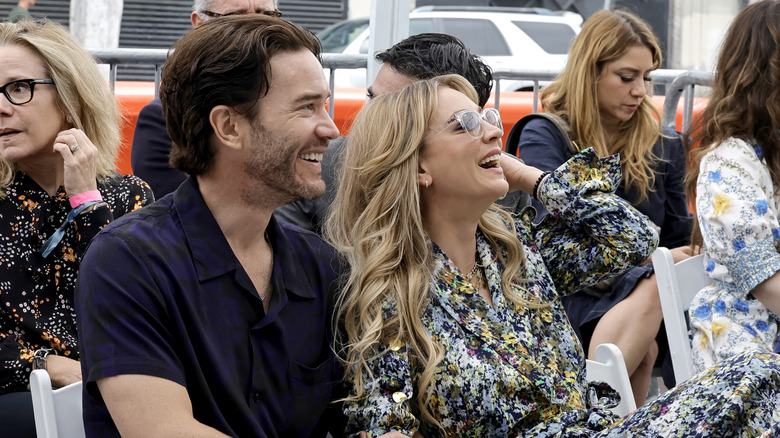 Tom Pelphrey and Kaley Cuoco laughing together.